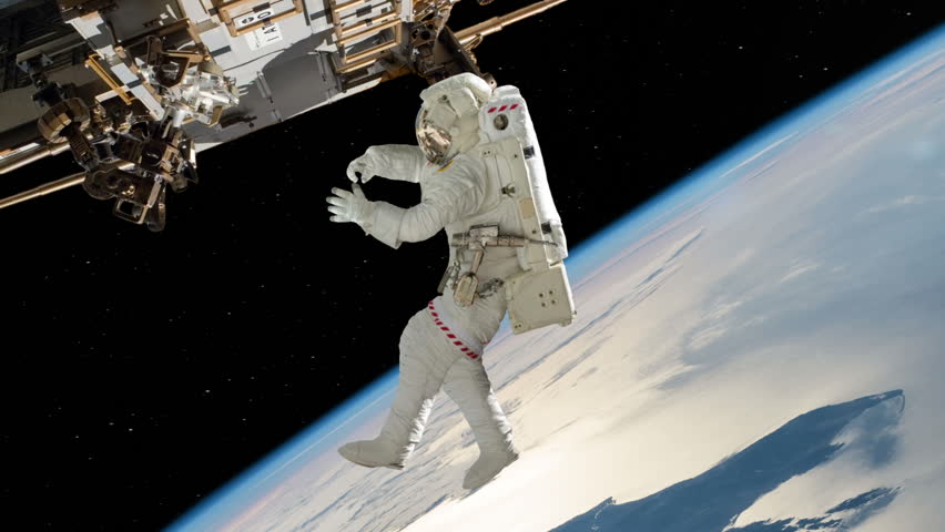 Astronaut Outside The International Space Station On A Spacewalk With A