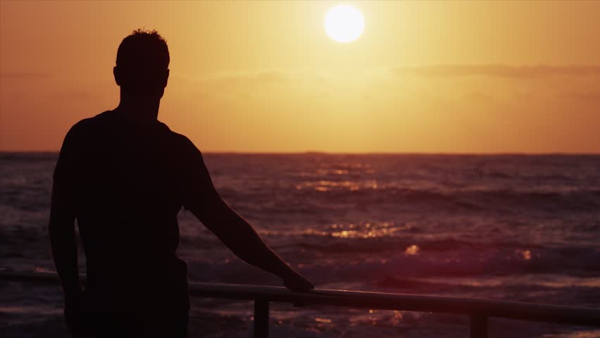 Silhouette Of Man Standing On Beach Watching Sunset Over Pacific Ocean Stock Footage Video 0479