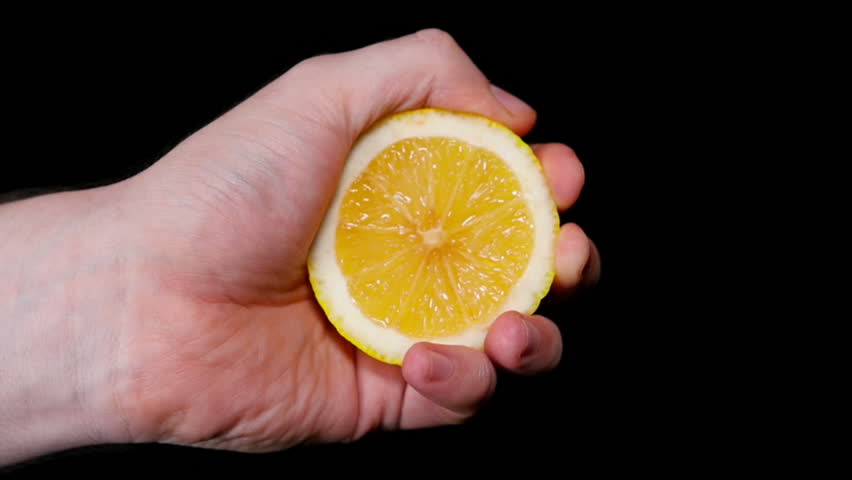 Hand Squeezing Lemon On Dark Background Stock Footage Video 3464789