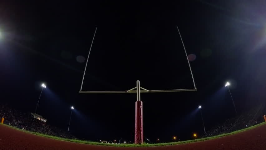 Dolly Of A High School Football Stadium Before The Game At Night. Stock