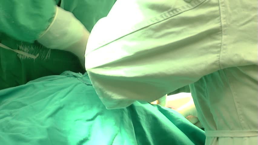 Caesarean Section Surgeon Cutting Stomach With Scalpel Extreme Close
