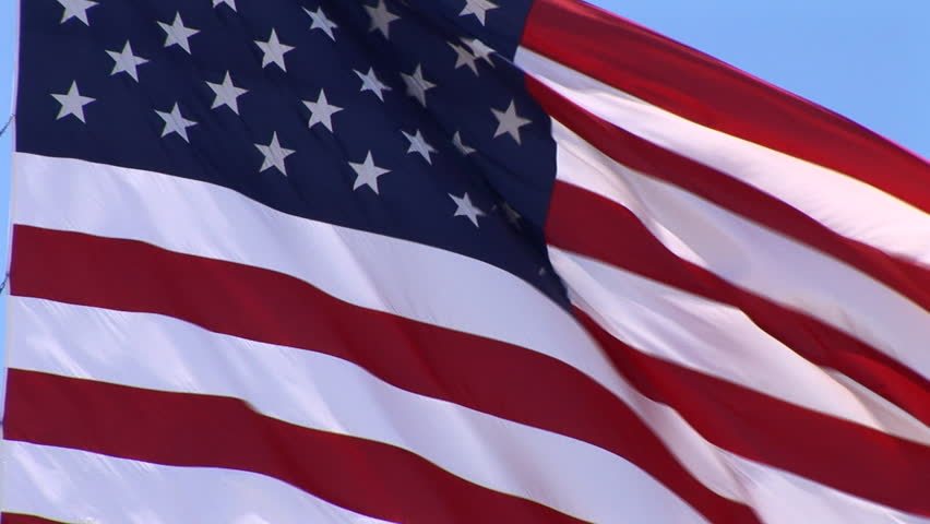 a-real-american-flag-waving-some-blue-sky-shows-through-at-times