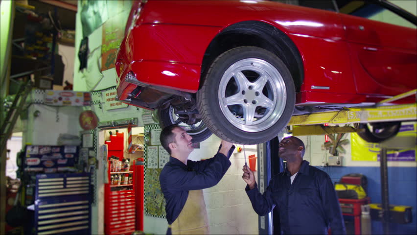 4k Mechanic Working Underneath A Car In Garage Workshop Stock Footage 