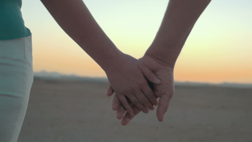 Holding Hands - Romantic Couple On Beach. Close Up Of Young Lovers ...