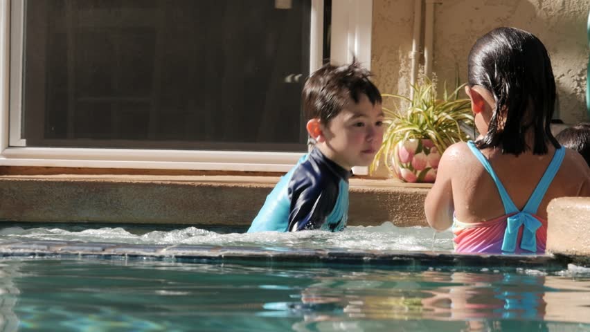 Mother Holding And Kissing Her Daughter In The Swimming Pool Stock ...