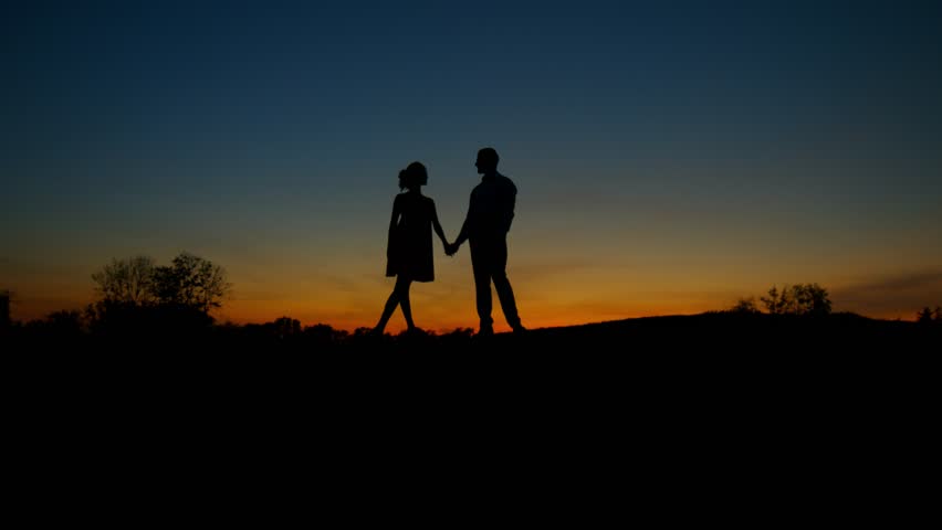 Couple Walks Into Sun Up Hill And Then Stops To Take In Romantic ...