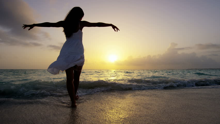 Happy Woman Dancing On The Beach At Sunset With Sea Background Stock ...