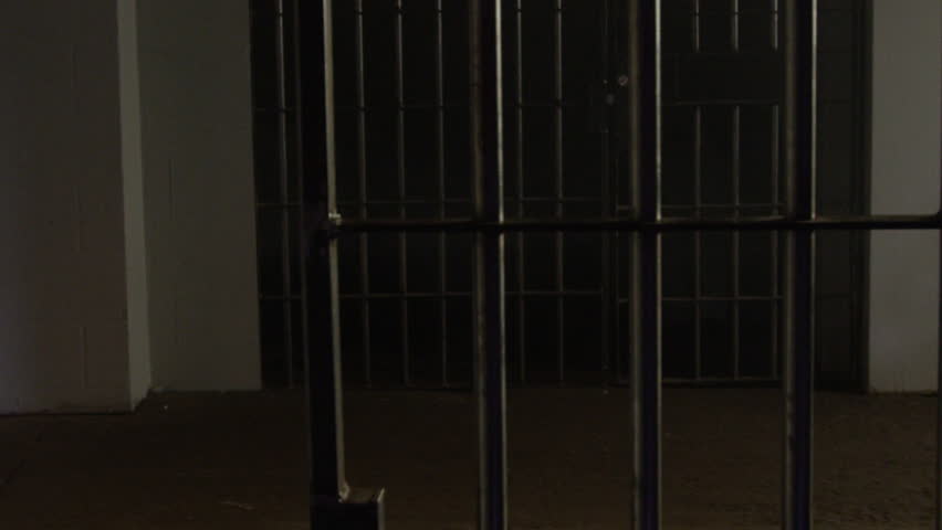 A Static Camera Closeup Of The Door Slamming Shut A Brick Jail Cell ...