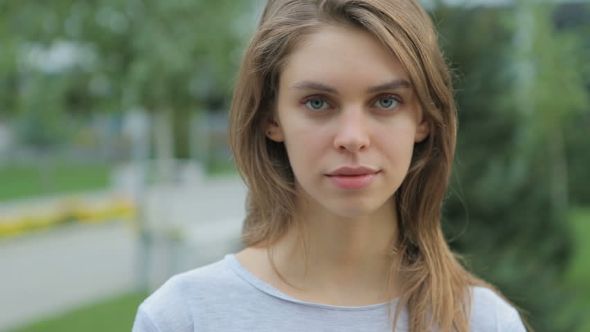 Beautiful Woman With Green Eyes And Brown Hair Goes To The Camera Slow