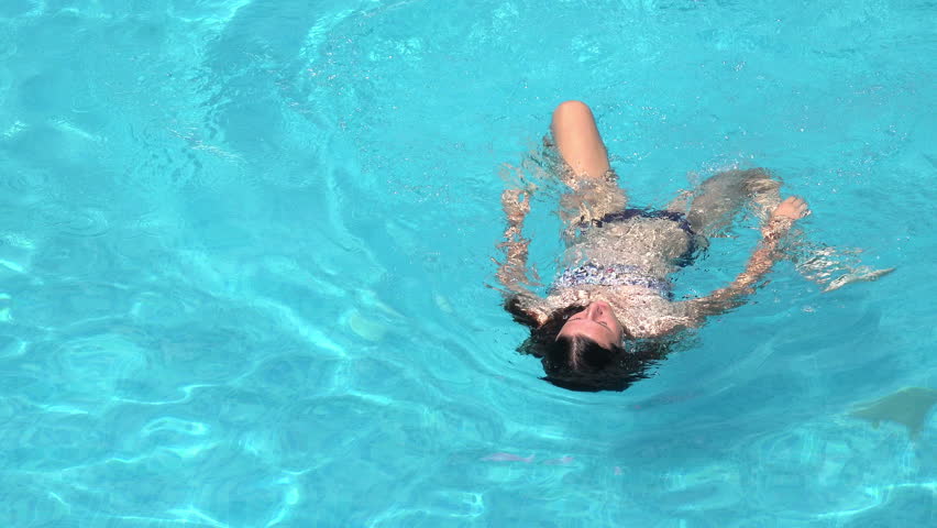 Brunette Swimming Underwater In The Pool In Slow Motion