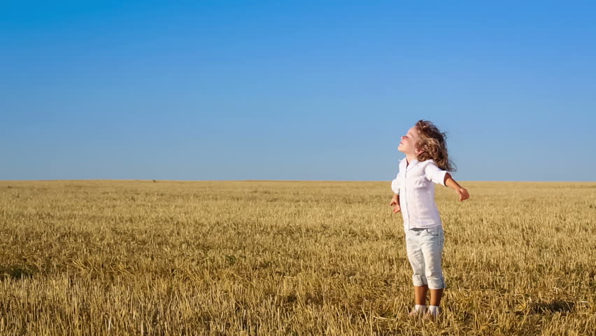 Happy Child Enjoying The Nature In Autumn Field Against Blue Sky ...