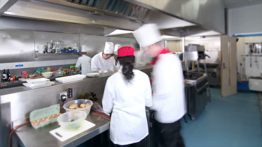 Busy Restaurant Kitchen time lapse clip of a busy team of chefs, working hard and Busy Restaurant Kitchen time lapse clip of a busy team of chefs, working hard and