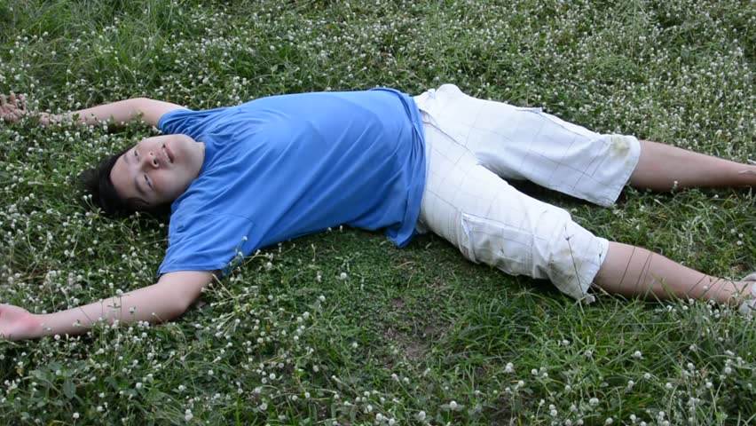 An Asian Thai Male Man Guy Is Drop Dead Or Unconscious On The Grassy ...