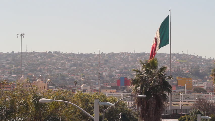 The Flag Of Mexico Flying High Above Tijuana Mexico At The US Border ...