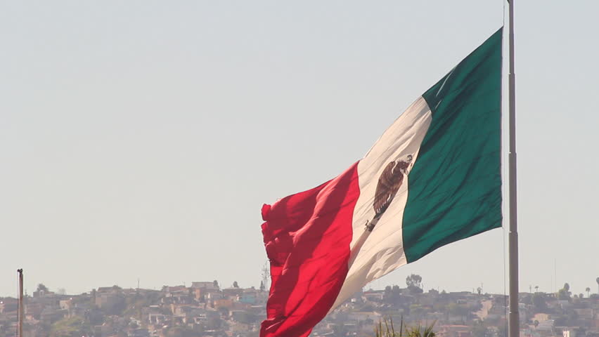 The Flag Of Mexico Flying High Above Tijuana Mexico At The US Border ...